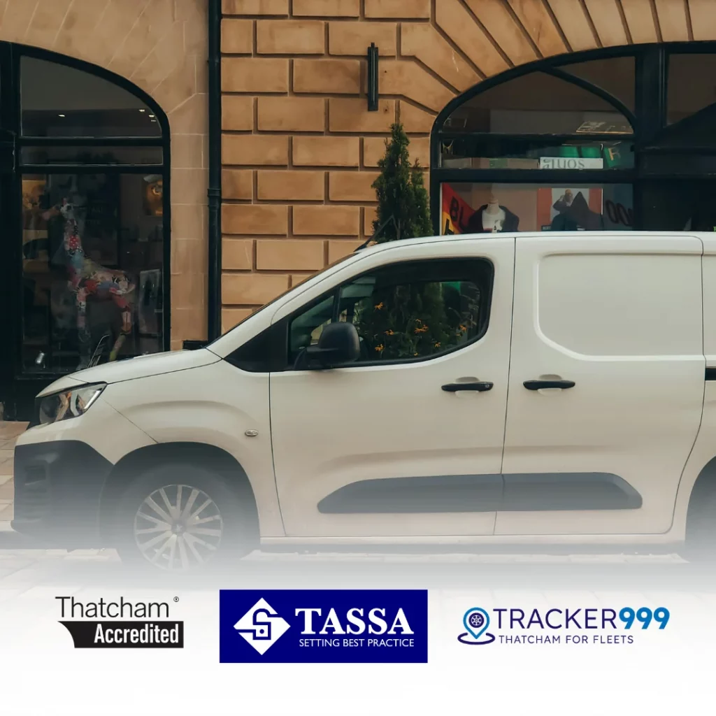 White van parked in urban area with Thatcham and TASSA approved vehicle tracking and immobiliser branding

