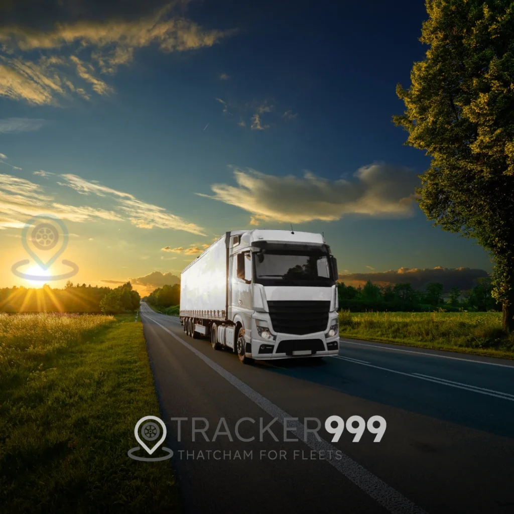 White articulated lorry on countryside road with fleet tracking logo and Tracker999 branding