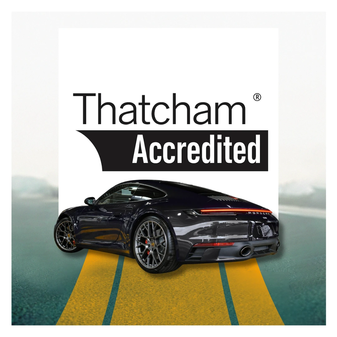 Rear view of black Porsche 911 with Thatcham Accredited sign in background